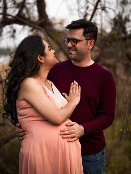 An intimate close-up of a couple during their outdoor shoot. The focus is on their loving gaze and gentle touch, capturing the deep emotional bond between them.