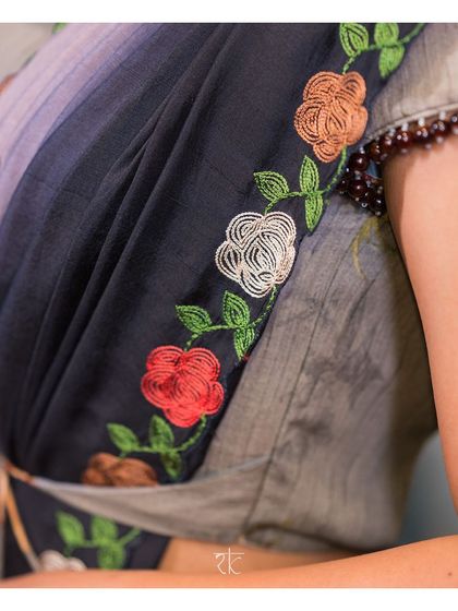 A close-up of the beautiful multi-colored floral embroidery that trails along the border of the saree's pallu.