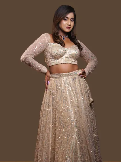 This is a great example of a modern reception or sangeet look. The hair is styled with soft, loose waves for a glamorous feel that works beautifully with this sparkling lehenga, offering a comfortable yet chic option for any party.