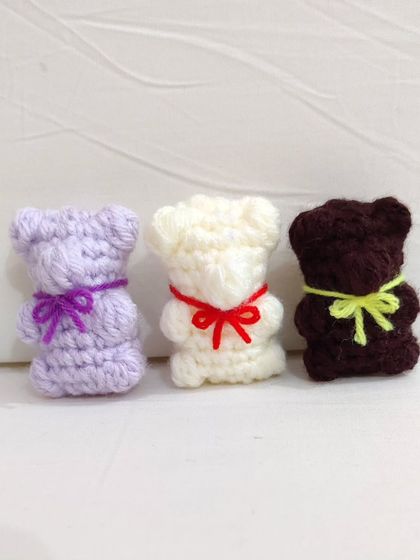 Cute and chewy-looking gummy bear keychains with little bows, available in white, brown, and lavender.