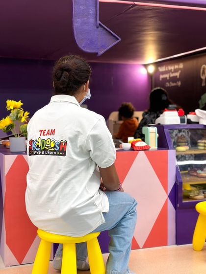 A member of Team Skadoosh keeping a watchful eye from the pretend play cafe. Our staff is always present and engaged, ensuring a safe and fun experience for everyone.