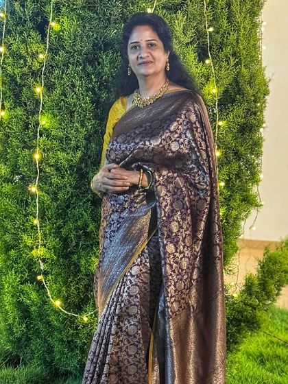 The intricate golden motifs of the Banarasi weave come alive in this photo, showcasing the luxury of artisan-crafted sarees.