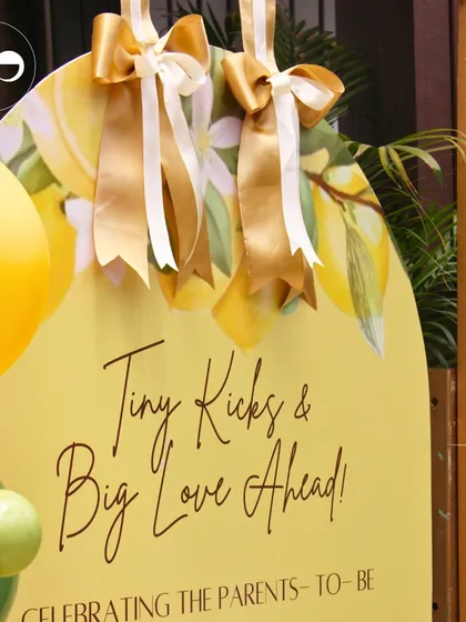 A close-up of the welcome sign for a citrus-themed baby shower. The sign, adorned with lemon illustrations and elegant ribbons, set a sunny and cheerful tone right from the entrance.