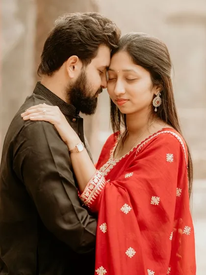 An intimate and serene portrait from a pre-wedding shoot at a historic location. The soft light and close embrace create a feeling of timeless romance.