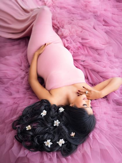 A creative overhead shot, with the mamma lying in a sea of pink tulle, with delicate flowers in her hair. It's a true work of art.