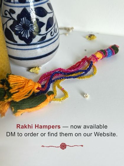 A close-up of a colorful, hand-braided Rakhi charm with tassels, included in our special festive hampers. These are now available to order through our website.