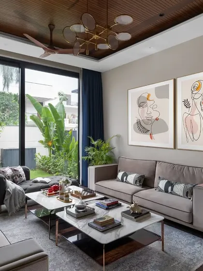 This living space in the Dua Residence is all about tranquility. The earthy tones, natural materials, and large windows looking out onto the garden create a peaceful retreat from the city.