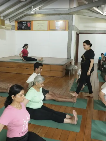 A glimpse into healing in action. Here I am walking through the class, observing and guiding students in Dandasana (Staff Pose). This personal attention is what ensures every student is on the right path.