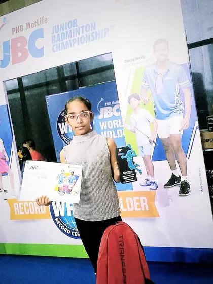 Akshita, one of our promising young players, posing with her certificate after securing 3rd place in the U-11 girls' singles at the PNB Metlife JBC. She even defeated the top-seeded player in the tournament.