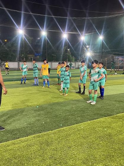 A coach leads a strength and conditioning session. We incorporate youth football fitness programs to build endurance and power.