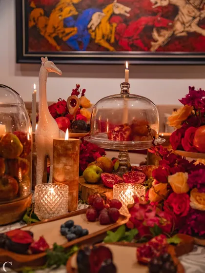 Beyond the grand scale of the runway, my passion lies in creating intimate, atmospheric tablescapes. This design combines deep reds, candlelight, and natural elements like fruits and wood to craft a warm, luxurious setting for a private gathering.