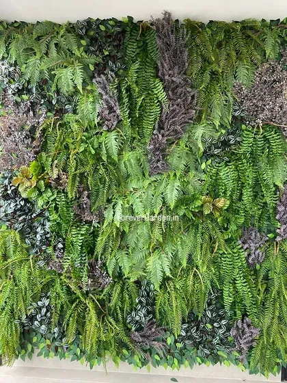 A close-up view of a vertical garden panel with a rich mix of green and purple-toned ferns and foliage.
