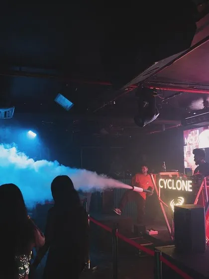 Using a handheld smoke gun at Cyclone in Nagpur to interact directly with the front rows. It's a great way to get up close and personal with the crowd.