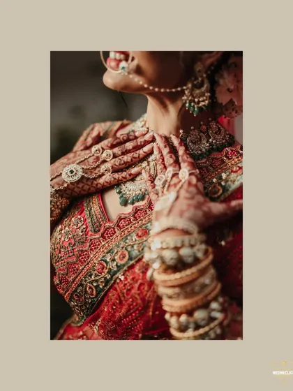 A close-up shot focusing on the intricate details of the bride's hands, mehendi, and jewelry.