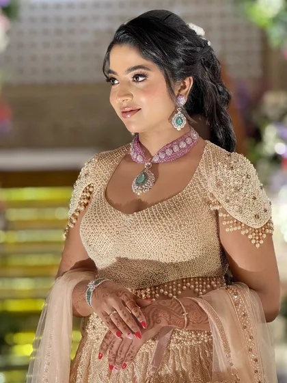A side profile of the bride, showcasing her elegant hairstyle and the intricate details of her jewelry.