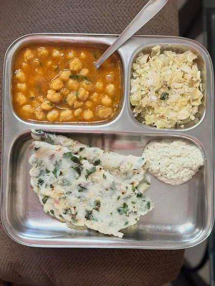 A simple yet complete meal of akki roti (rice flour flatbread), channa masala (chickpea curry), and cabbage palya. This demonstrates a classic combination of carbs, protein, and vegetables.