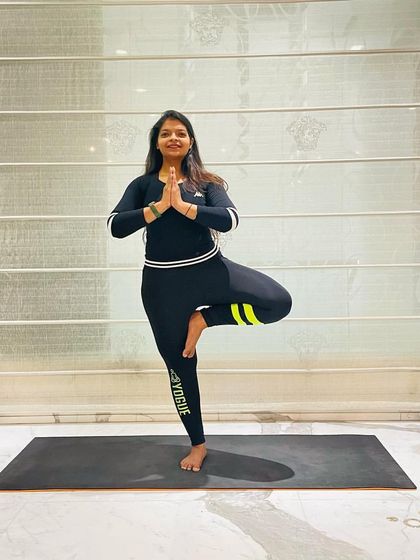 Vrikshasana, or Tree Pose, is the pose of the day. It's a beautiful balancing asana that improves focus and strengthens your legs and core. And don't forget to smile.