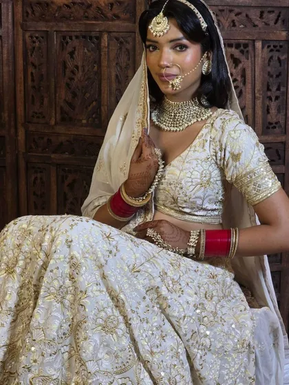 An elegant ivory and gold lehenga, perfect for a sophisticated day wedding or reception. The simplicity of the colour allows the intricate gold embroidery to truly shine.