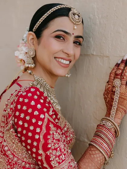 The pure joy of a bride on her wedding day is my biggest reward. For Varsha's Anand Karaj ceremony, we created a luminous, soft-focus look with clean lines and a radiant finish that honored the sanctity of the occasion while letting her happiness shine through.