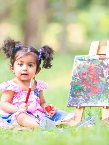 Every child is an artist. In this themed session, I provided a mini easel and non-toxic paints to let this little one express her creativity, resulting in genuine and colorful portraits.