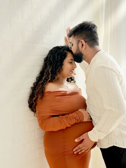 We focus on capturing the quiet, intimate moments between expecting parents. This high-key couple portrait highlights the connection and joy of your journey together in our comfortable studio setting.