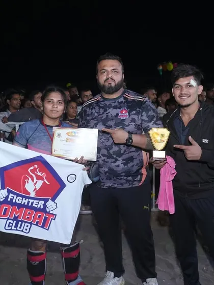 Me with our victorious fighters, Heena and another champion, holding their trophies and the FCC flag. This is what we work for.