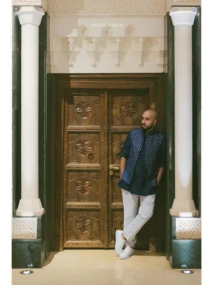 Posing between two grand pillars in Marrakech. The venues here are all about making a grand statement.