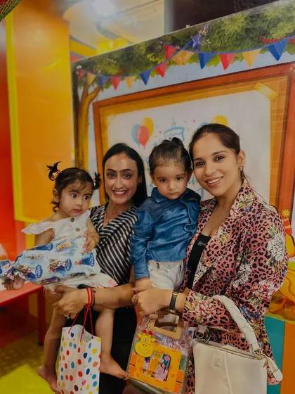 A beautiful photo of mothers and their children celebrating a birthday together. Our club is a community for parents as much as it is for kids.