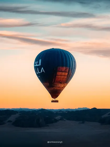 A hot air balloon floats gracefully against the sunset sky in AlUla. This was one of my favorite moments from Saudi Arabia, capturing the serene beauty of the desert from the air.