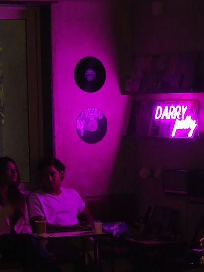 The vibe at Darry's House was perfect, with neon signs and vinyl records on the wall. A great backdrop for a dreamy show.