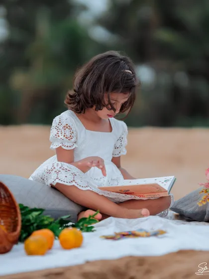Sometimes the most precious moments are the quietest. Here, a young girl is completely absorbed in her book during our beach session. I believe in capturing kids just being kids, whether they are running wild or lost in a story.
