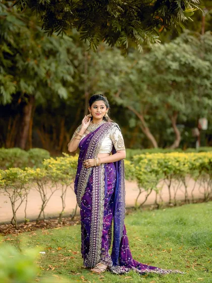 The elegant posture and the rich attire make this a picture-perfect festive look.