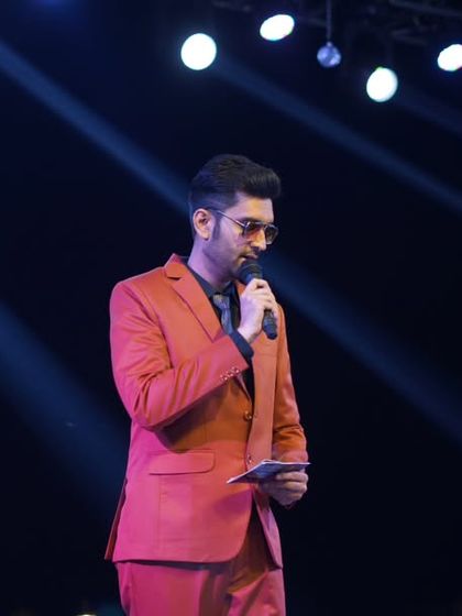 A moment of focus before the next announcement. Even in a high-energy sangeet, there are moments that require calm and collected delivery, and I transition between them smoothly.