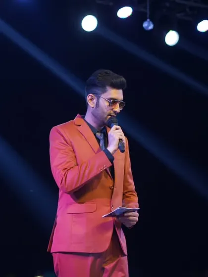 Reviewing my notes on stage. Preparation meets performance under the spotlight.