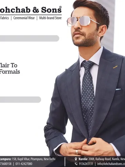 It is the small details that add flair to your formal wear. This close-up shows the precise fit around the shoulders and the perfect knot of the tie, elements we focus on in our custom tailoring service.