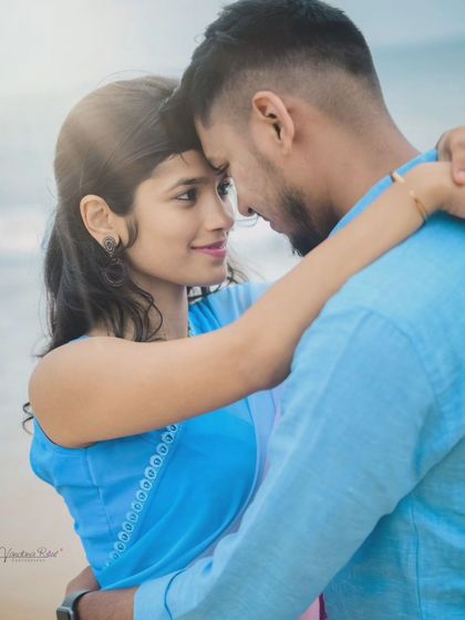 The beach provides a perfect canvas for romantic and playful couple portraits. This destination shoot captures a classic lift against the backdrop of the waves and open sky.