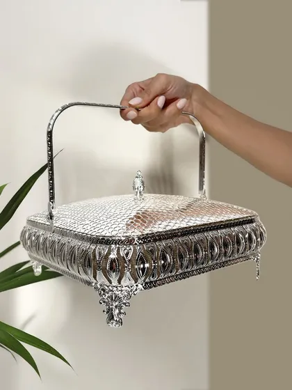 A glimmering touch of charm. This intricately crafted silver basket with a snakeskin-textured lid is perfect for festive gifting, decor accents, or simply to treasure something special.