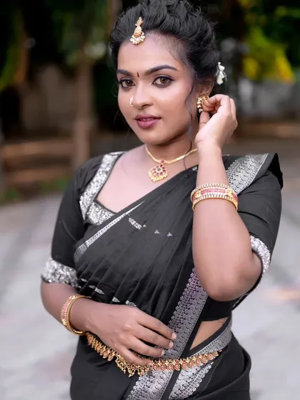 Another angle of the bold and beautiful black saree look. The makeup is flawless and complements the modern, chic styling.