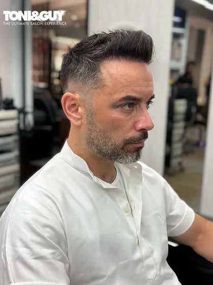 There's nothing better than the feeling of a fresh haircut. This client is rocking a classic, clean-cut style with a slight fade, looking sharp and confident.