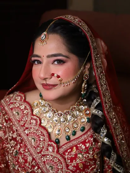A beautiful close-up of our bride, showcasing the flawless skin finish and the intricate details of her nath and maang tikka.