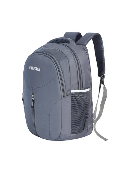 An angled shot of a grey American Tourister backpack, giving a dynamic view of the product.