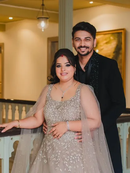 A classic and elegant portrait of the couple in a beautifully lit corridor, capturing a moment of quiet togetherness.