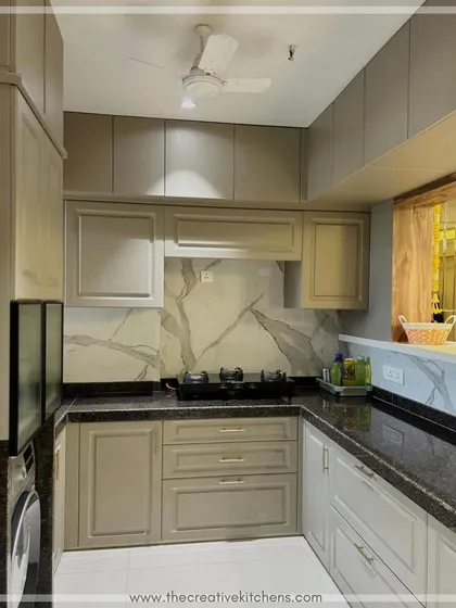 Every detail is considered, from the under-cabinet lighting that provides excellent task illumination to the choice of hardware that complements the European-style shutters. The result is a kitchen that is both beautiful and highly functional.