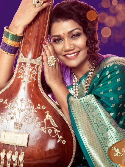 A beautiful, smiling portrait of me with a tanpura. This image is part of a series explaining the history and significance of Indian classical music and its iconic instruments.