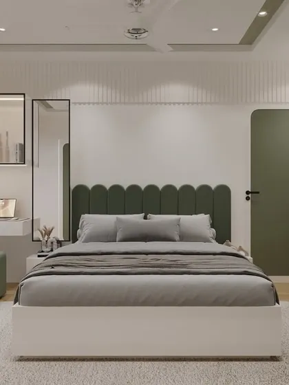 This bedroom is a perfect example of soft minimalism. The custom wardrobe with its unique rounded-edge doors in olive green becomes a design feature, not just storage. I paired it with a scalloped headboard and a built-in window seat to create a space that is peaceful, functional, and full of personality.