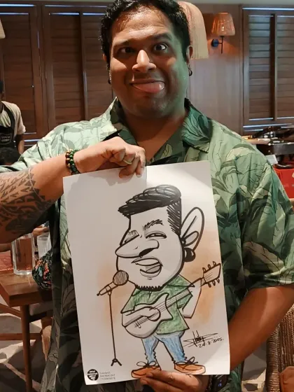 The artist becomes the art. Here I am holding the caricature I drew of the musician from the previous photo, showing the fun resemblance and exaggerated style.