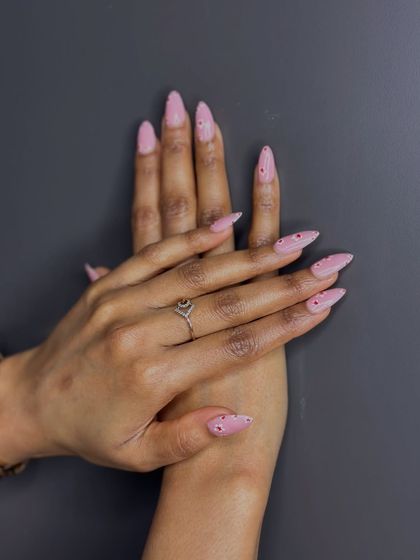 Another pose showcasing the elegant and minimalist dotted nail art, a versatile and trendy design.