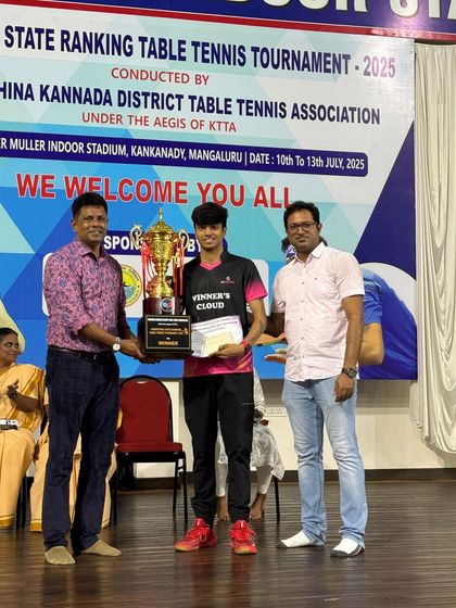 K J Akash receiving the Men's Singles Title trophy at the 3rd Karnataka state ranking tournament in Mangalore.