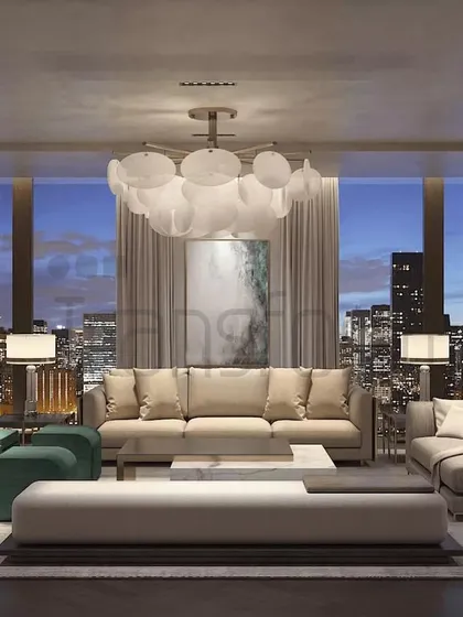 In this DLF Camellias residence, I crafted a living room that balances modern sophistication with deep comfort. The neutral palette creates a serene backdrop for the city skyline, while the plush teal accent chairs and bespoke shelving provide both personality and function.
