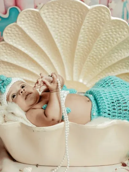 Let's bring your dreams to life. For this session, we created a magical underwater world for a tiny mermaid, complete with a seashell bed and delicate pearls. I have many creative themes we can explore.